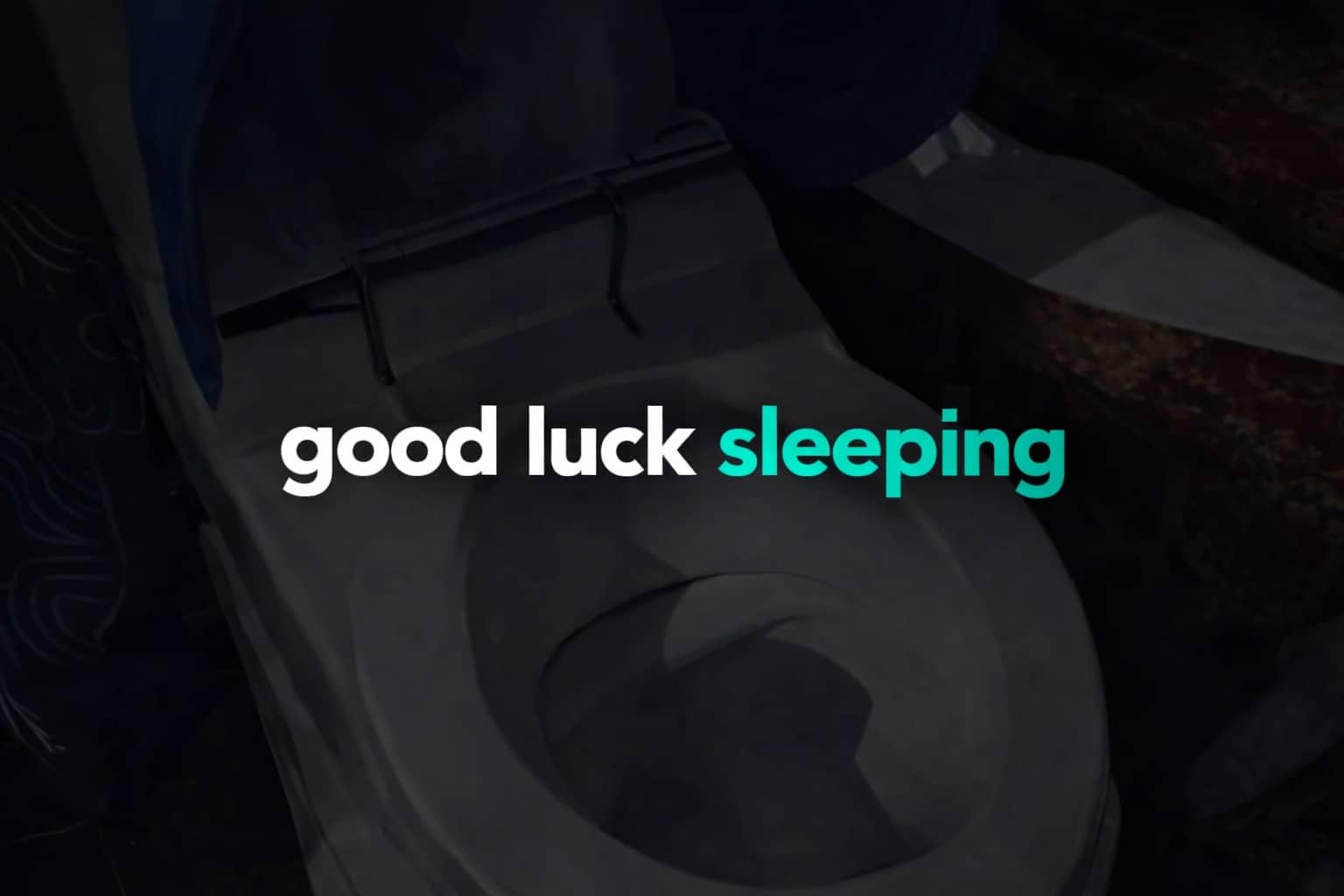 A dark and eerie bathroom interior showing a toilet with the text good luck sleeping.