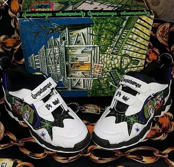 Goosebumps themed sneakers with spiderweb design and boo dude strap text.