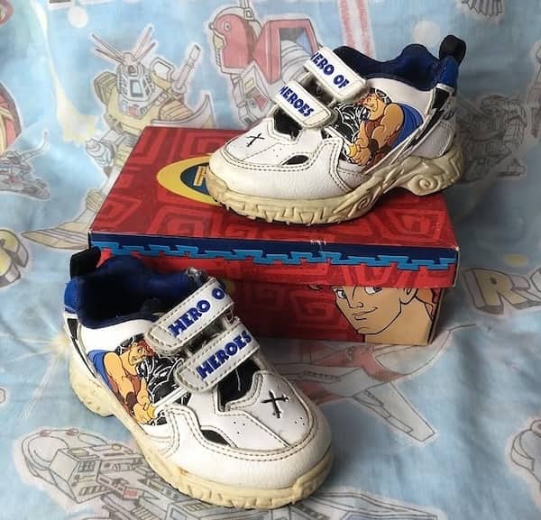 White sneakers featuring Disney Hercules character art and hero strap text.
