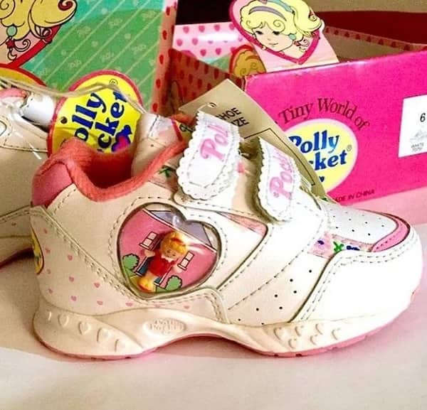 Polly Pocket sneakers with clear heart bubble containing miniature doll figure.