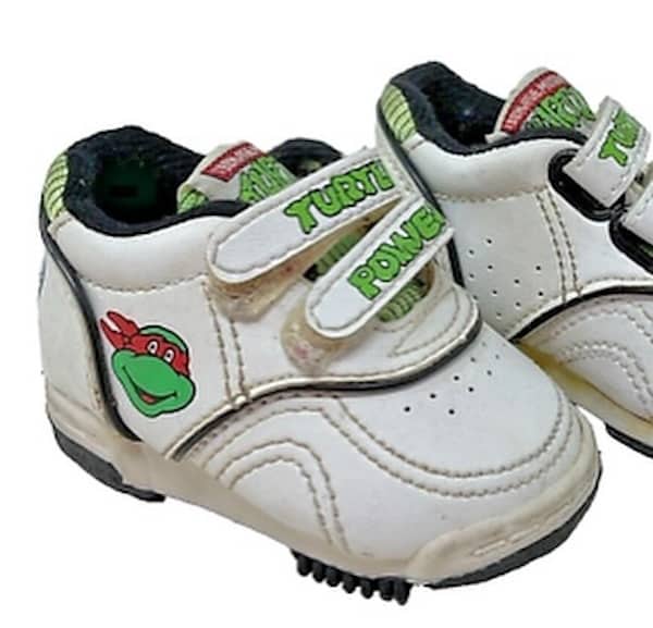 Teenage Mutant Ninja Turtles sneakers with Raphael face and turtle power strap.