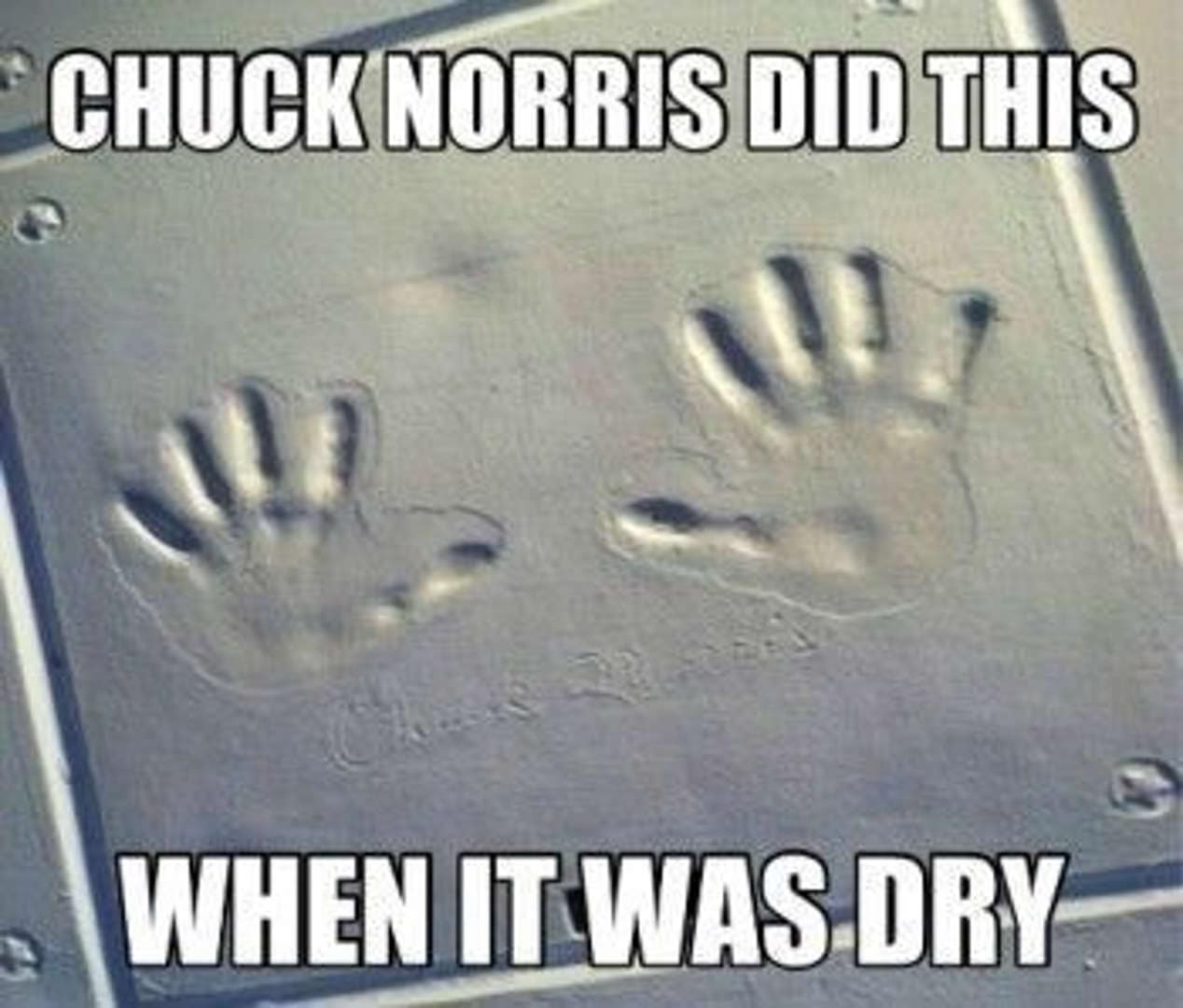 A photo of two deep handprints pressed into what appears to be solid, weathered stone. The caption reads: "CHUCK NORRIS DID THIS WHEN IT WAS DRY."