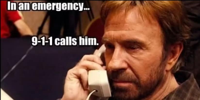 A close-up of Chuck Norris intensely listening on a landline telephone. The caption states that in an emergency, it is actually 9-1-1 that calls him for help.
