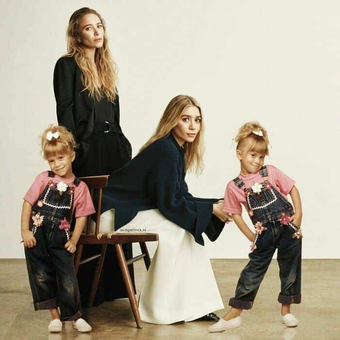 Mary-Kate and Ashley Olsen posing with their child actor selves.