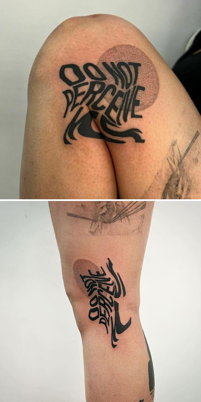 "Do not perceive" text tattoo on the thigh that stretches and warps near the knee.