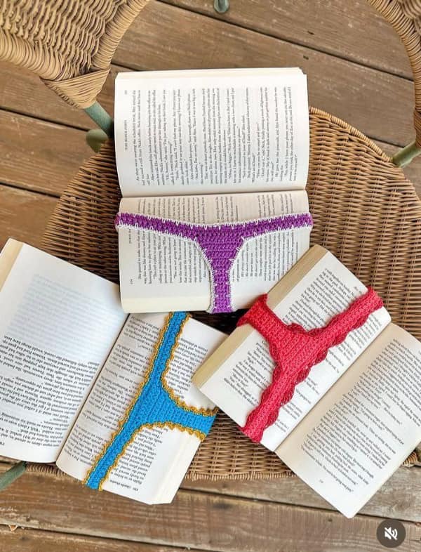 A hilarious creative knitting project showing bookmarks shaped like colorful thong bikinis placed in books.