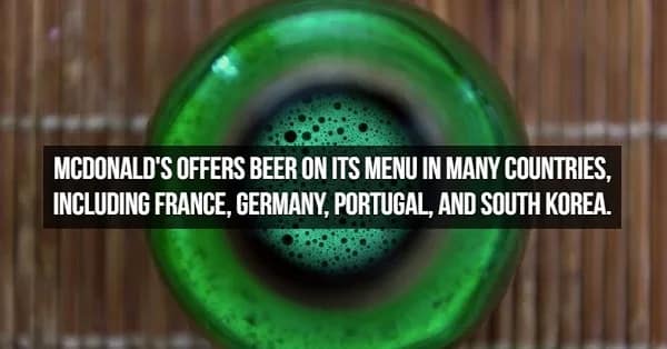 A unique bird’s-eye view looking down into the neck of a bubbling green beer bottle. The text shares a surprising global fact about beer: McDonald's serves it on the menu in several countries, including Germany, France, Portugal, and South Korea.