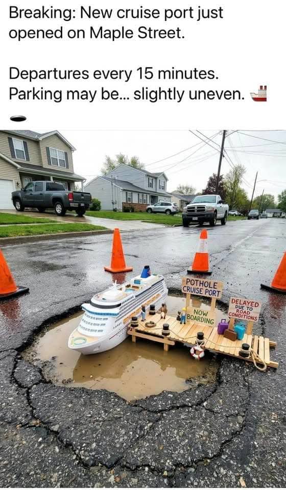 Miniature cruise ship and dock set up inside a large water-filled pothole on a street.