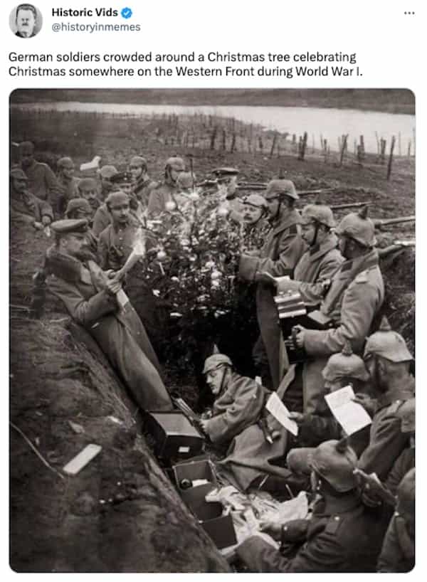 German soldiers crowded around a Christmas tree celebrating Christmas somewhere on the Western Front during World War I.