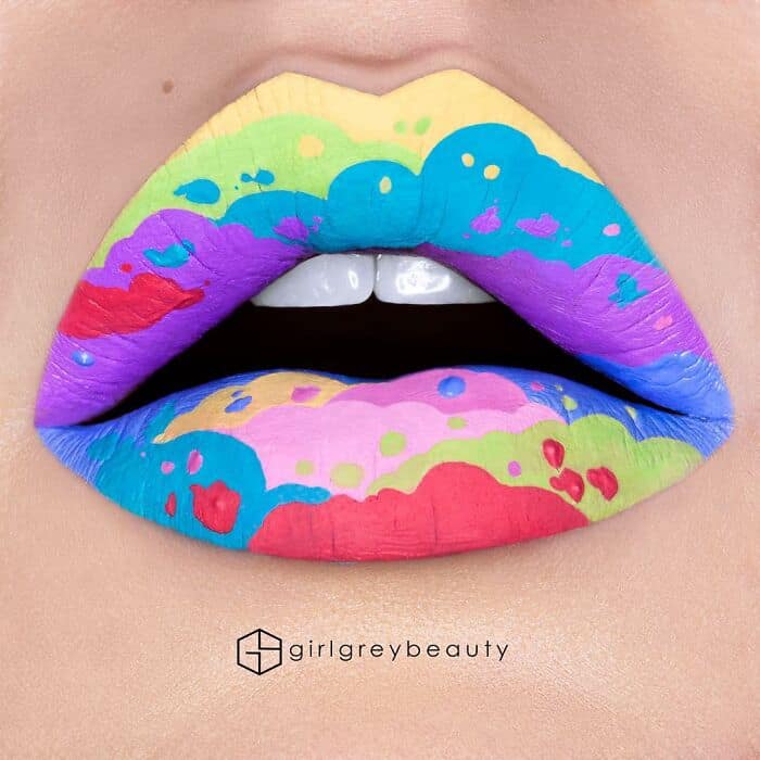 A wildly vibrant and psychedelic amazing lip art featuring layered, melting clouds in bright neon rainbow colors, demonstrating the flawless color-blocking techniques of Andrea Reed lip art.