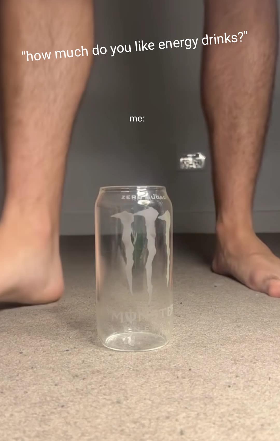 A high-risk funny meme referencing a viral shock video. It shows a person's legs standing over a clear glass jar with a Monster Energy logo, captioned with a question about how much they like energy drinks.