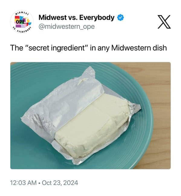 culinary midwest meme featuring a simple photo of a block of cream cheese on a blue plate. The caption accurately identifies it as "The 'secret ingredient' in any Midwestern dish," referencing its role in countless casseroles, dips, and desserts.