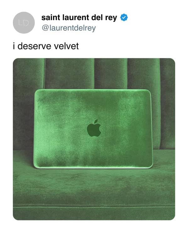 An Apple MacBook laptop completely covered in a luxurious, soft green velvet material.