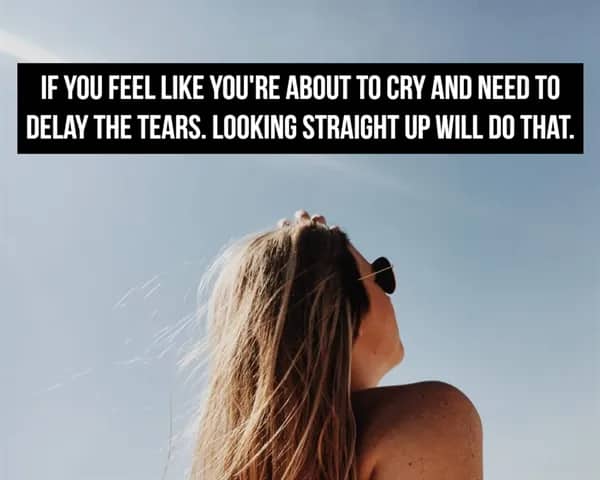 A woman looking up at the sky with text about using eye positioning to delay crying.