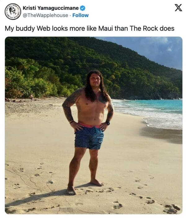 A comparison Moana live action meme tweet from Kristi Yamaguccimane. It shows a man named "Web" standing on a beach, shirtless with tattoos and long, natural curly hair, with a caption claiming he looks more like Maui than The Rock does.