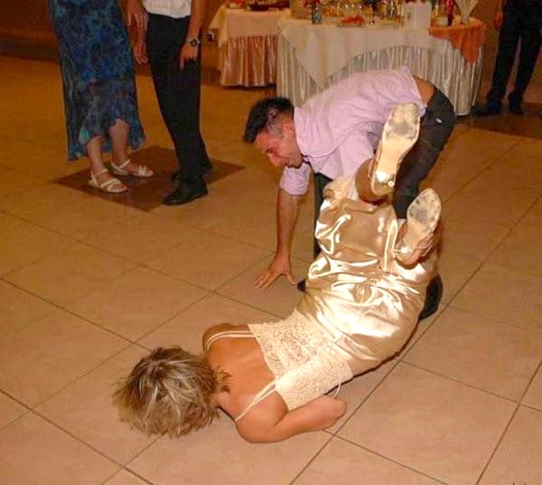 Man accidentally dropping woman face first onto dance floor during wedding reception.