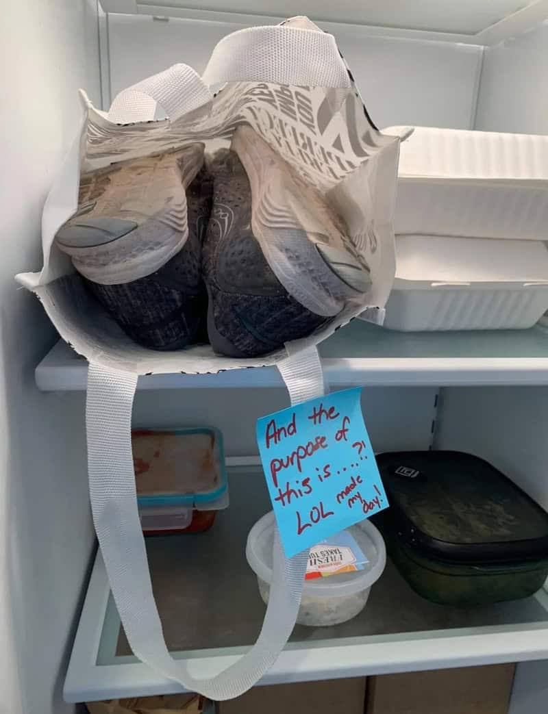 Muddy running sneakers stored in bag inside office fridge with confused sticky note response